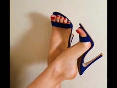 Beautiful feet in blue sandals and red enamel