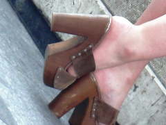 Candid sexy brunette in high heels mules